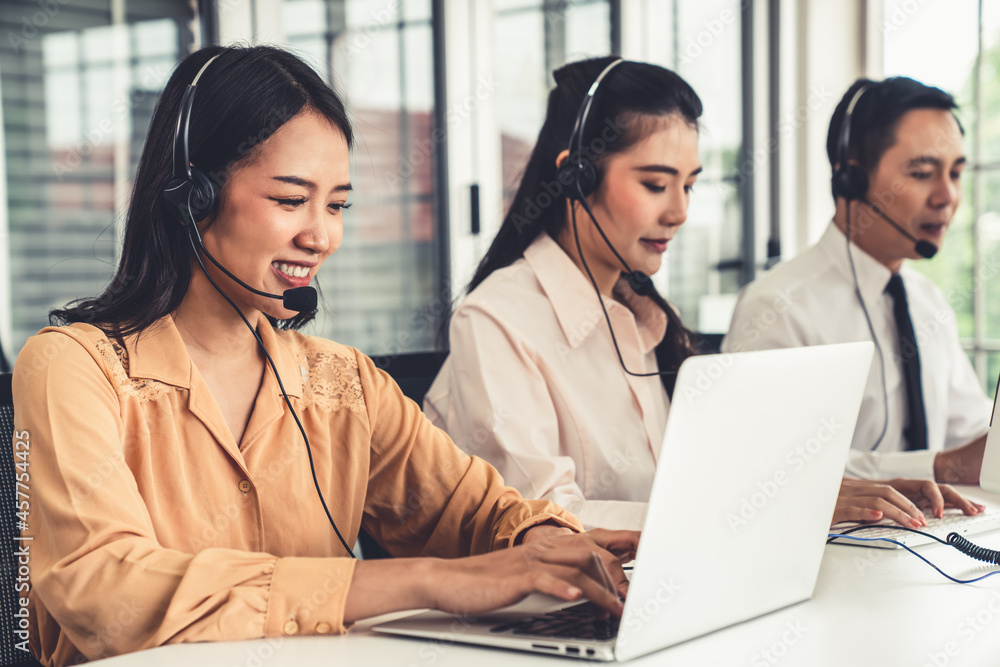 Business people wearing headset working actively in office . Call center, telemarketing, customer su