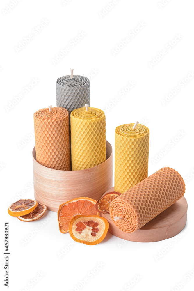 Box with candles and dried orange on white background