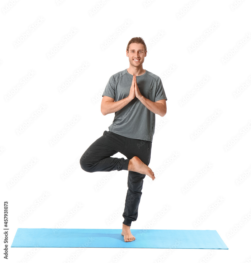 Young man practicing yoga on white background