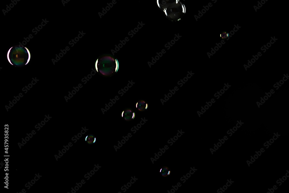 Soap bubbles on dark background, closeup