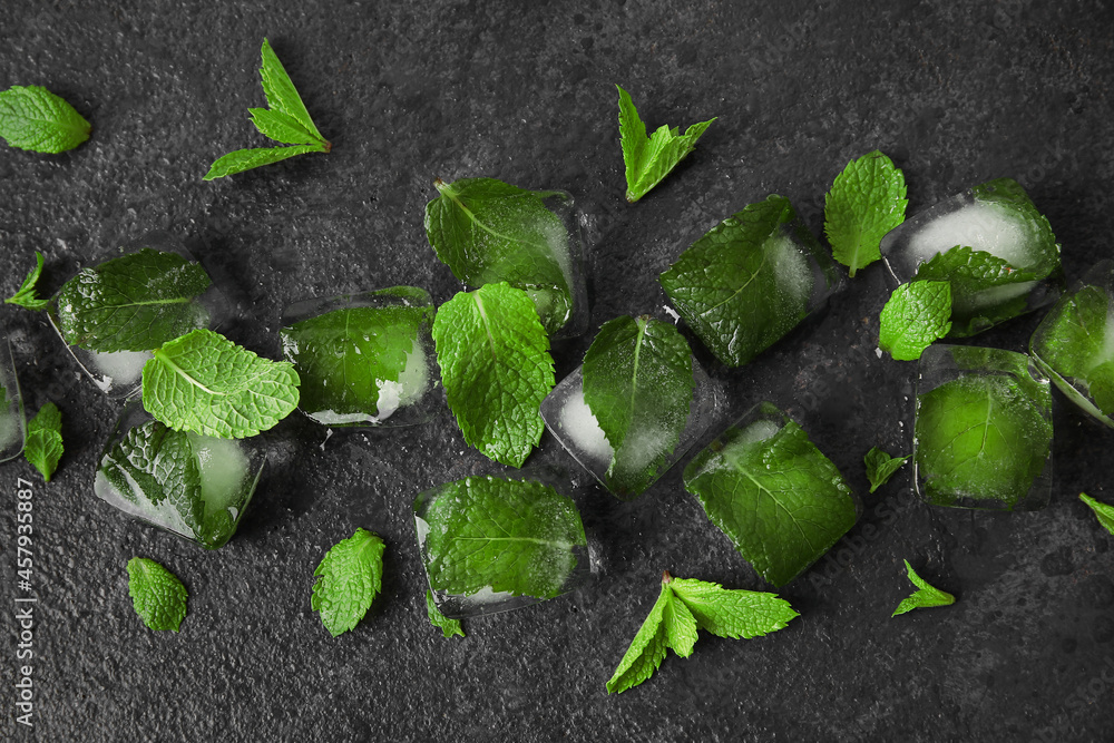 Ice cubes and mint leaves on dark background