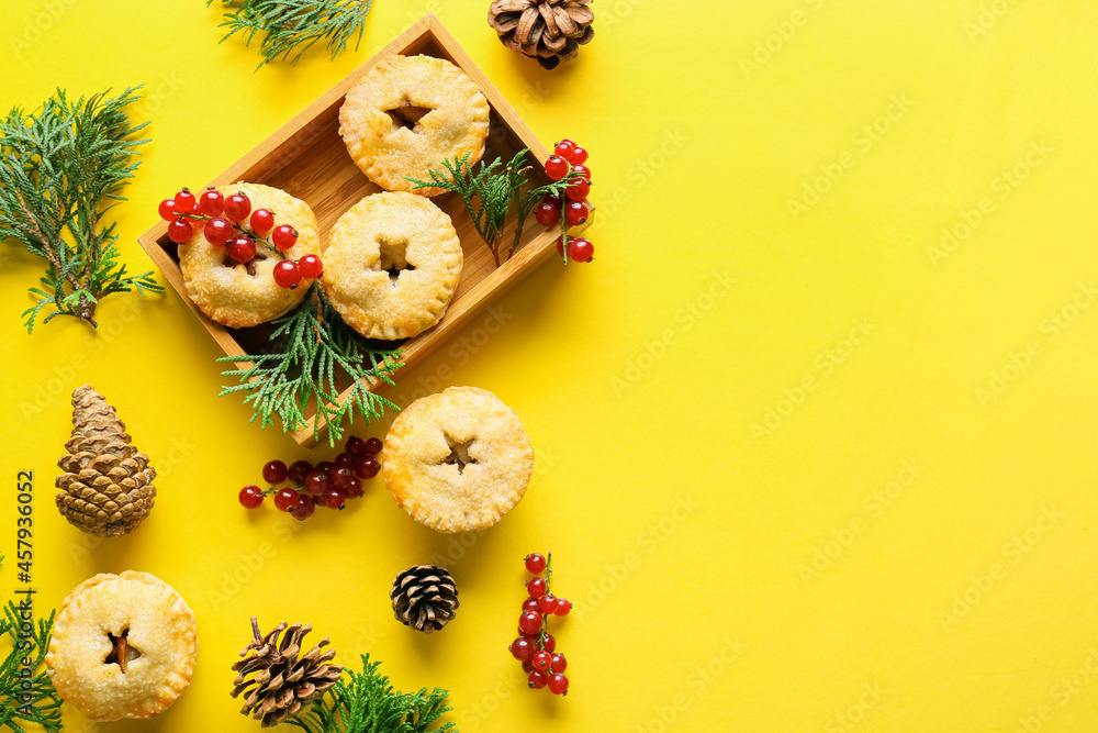 Composition with delicious Christmas mince pies, cranberry, cones and fir branches on color backgrou