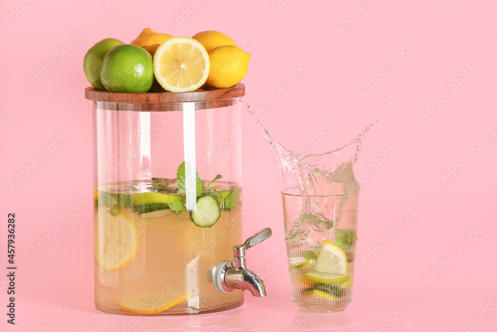 Jar and glass of lemonade with splash on color background