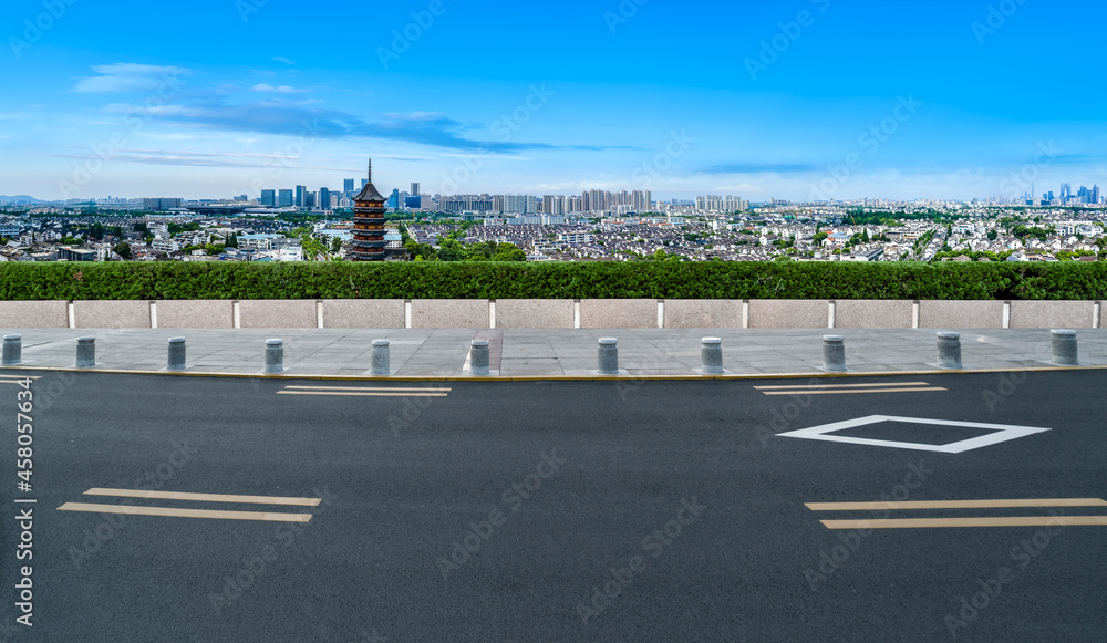 Panoramic skyline and empty asphalt road with modern buildings