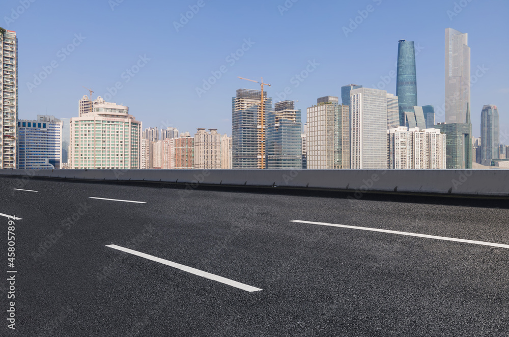 Panoramic skyline and empty asphalt road with modern buildings