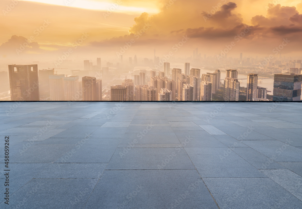 Panoramic skyline and empty square floor tiles with modern buildings