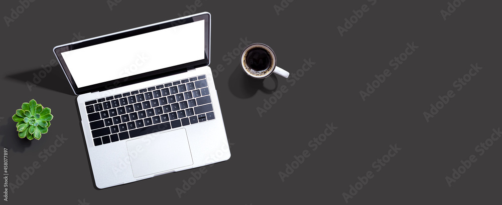 Laptop computer with a coffee cup from above