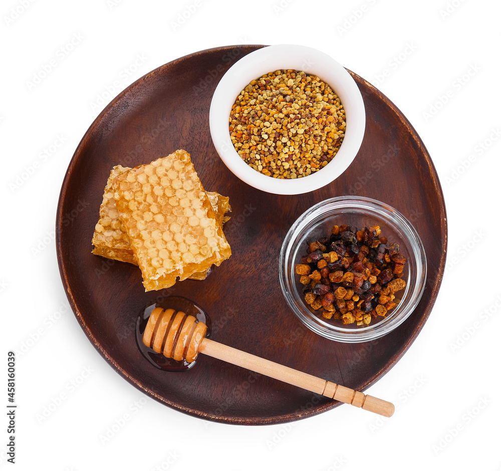 Plate with honey and bee products on white background