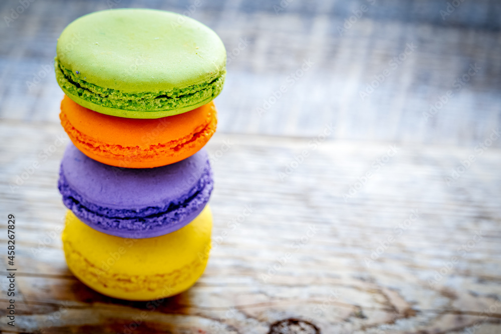 pile of multicolored macaroon cookies on a wooden table