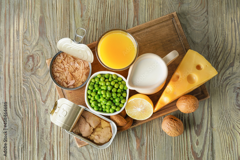 Different healthy products with vitamin D  on wooden background