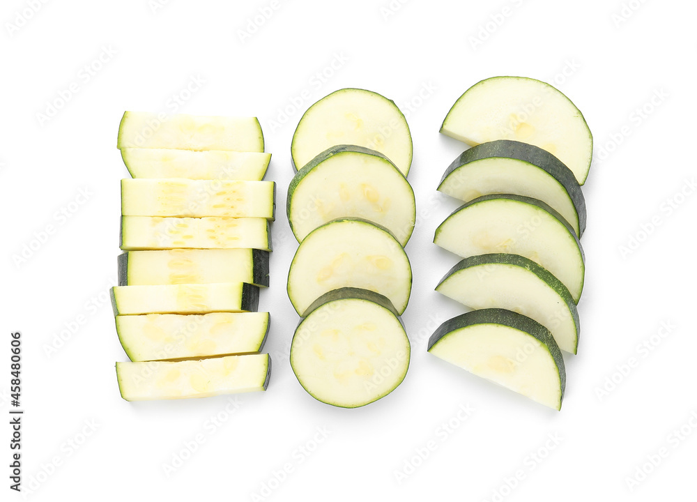 Slices of fresh zucchini squash on white background