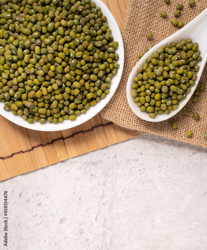 Raw mung bean on wooden table background.