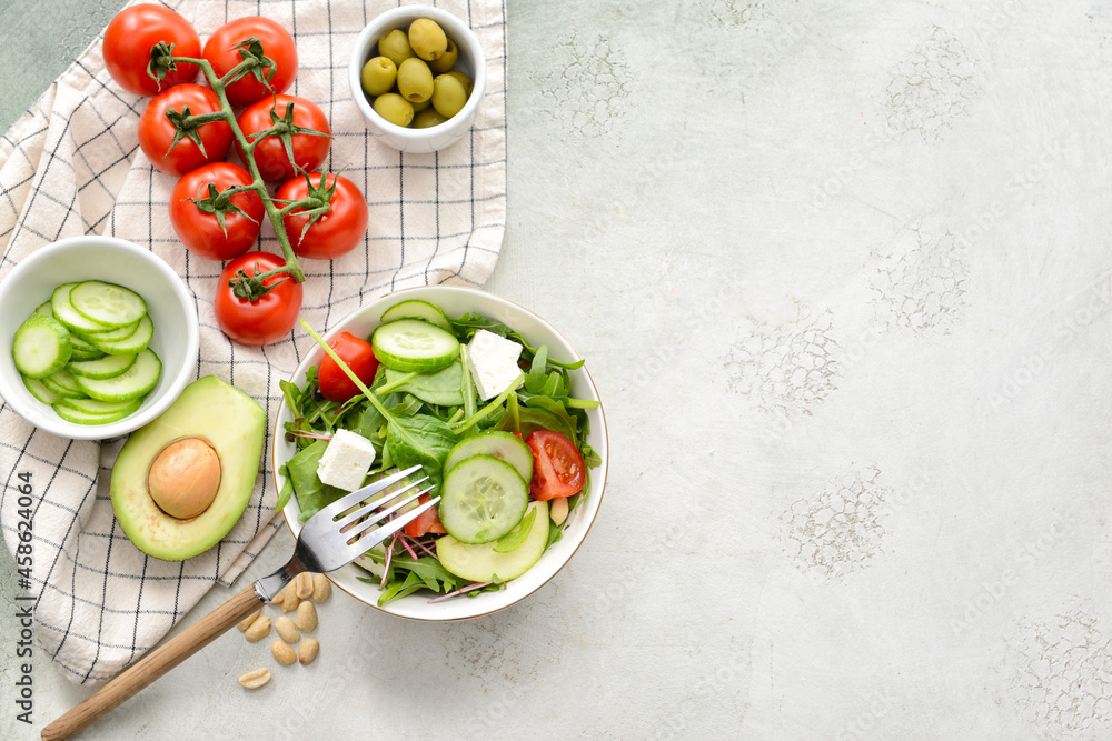 Plate with healthy salad on light background