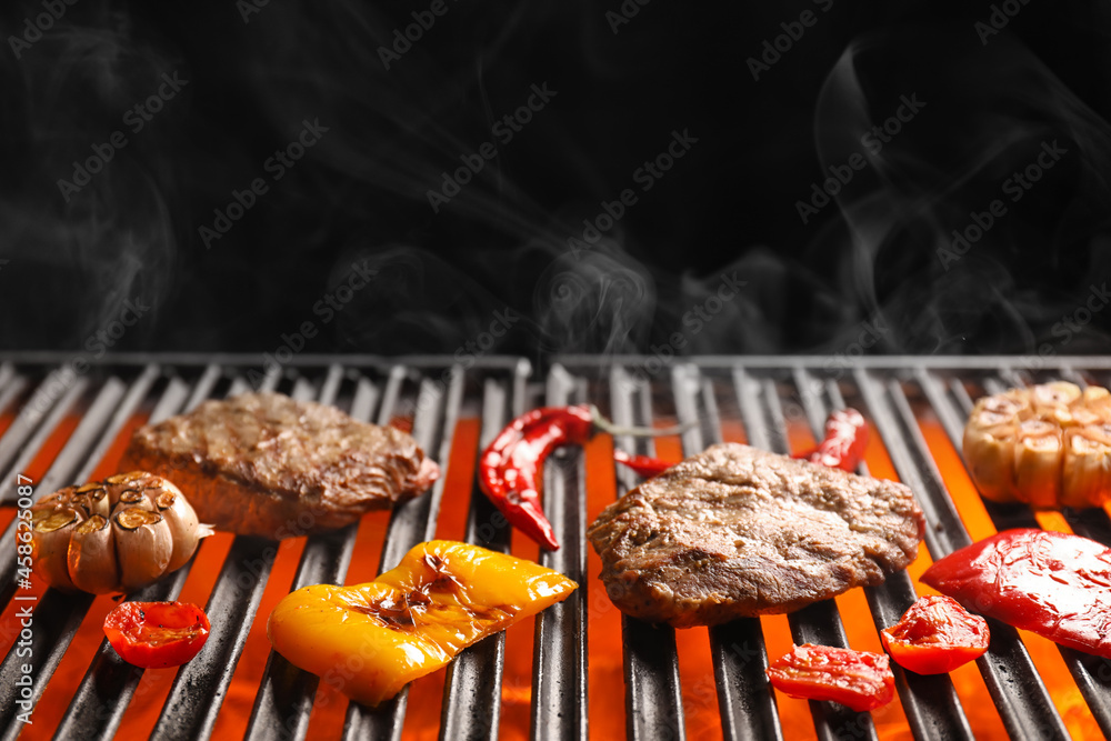 Tasty beef brisket with vegetables on barbecue grill