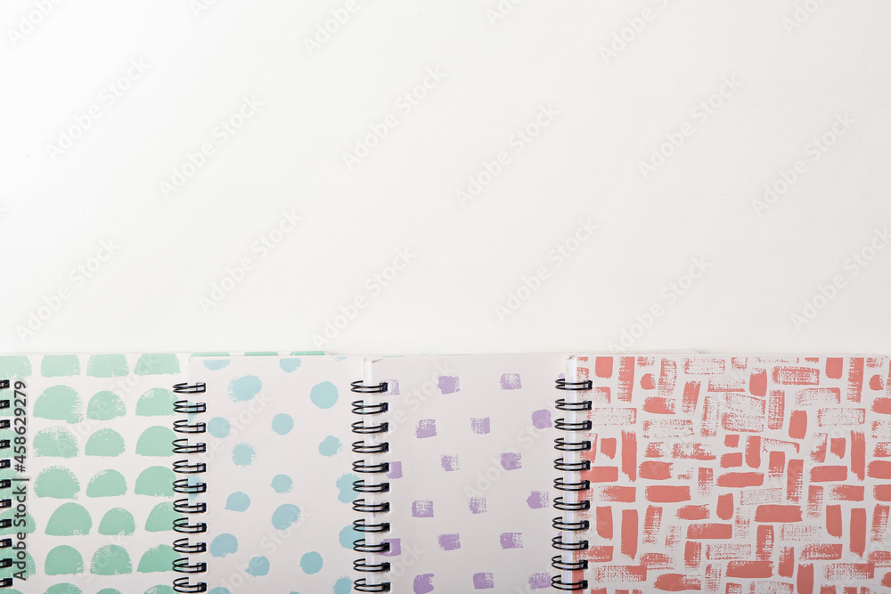 Stylish notebooks on white background, closeup