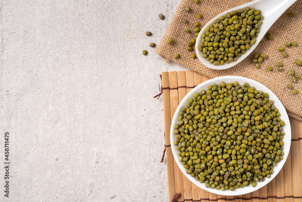 Raw mung bean on wooden table background.