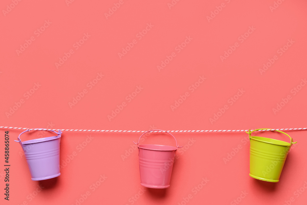 Different buckets on pink color background