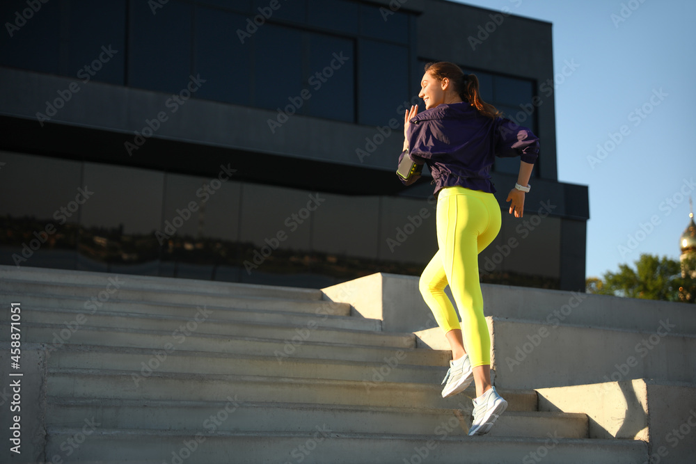 Sporty young woman running outdoors