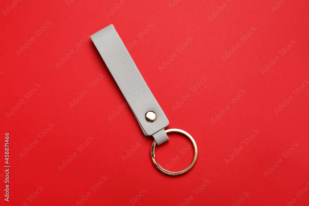 Leather keychain on color background