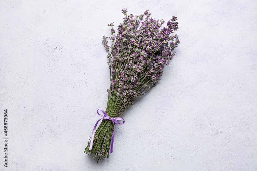 Bouquet of fresh lavender flowers on color background