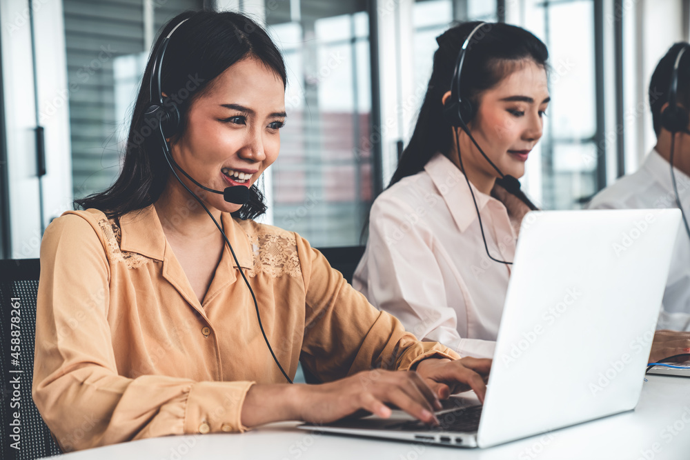 Business people wearing headset working actively in office . Call center, telemarketing, customer su