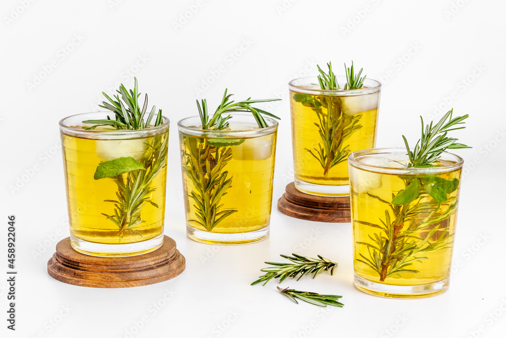 Fefreshing drink of cold tea and rosemary herbs in glasses