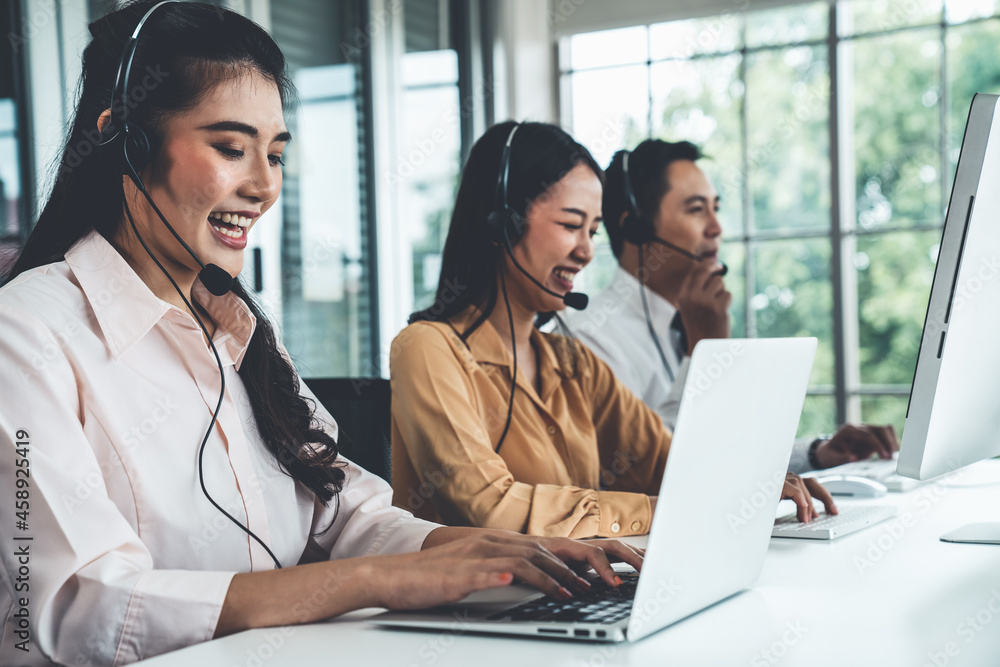 Business people wearing headset working actively in office . Call center, telemarketing, customer su