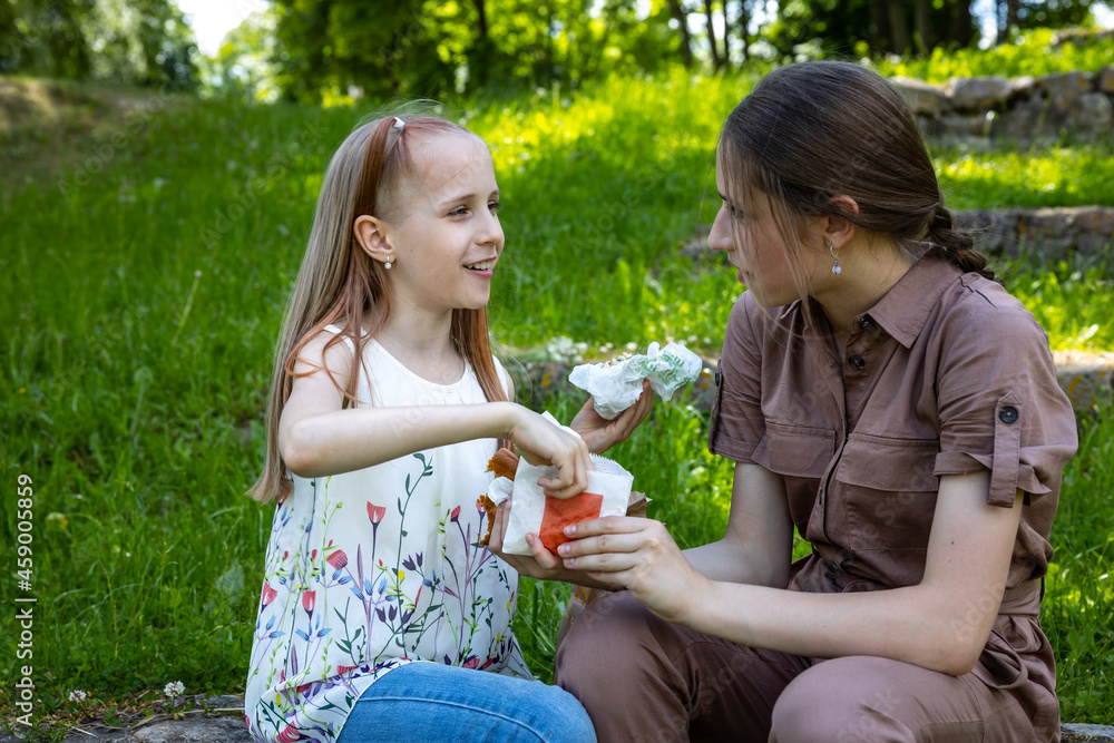 Happy sisters have picnic outdoor