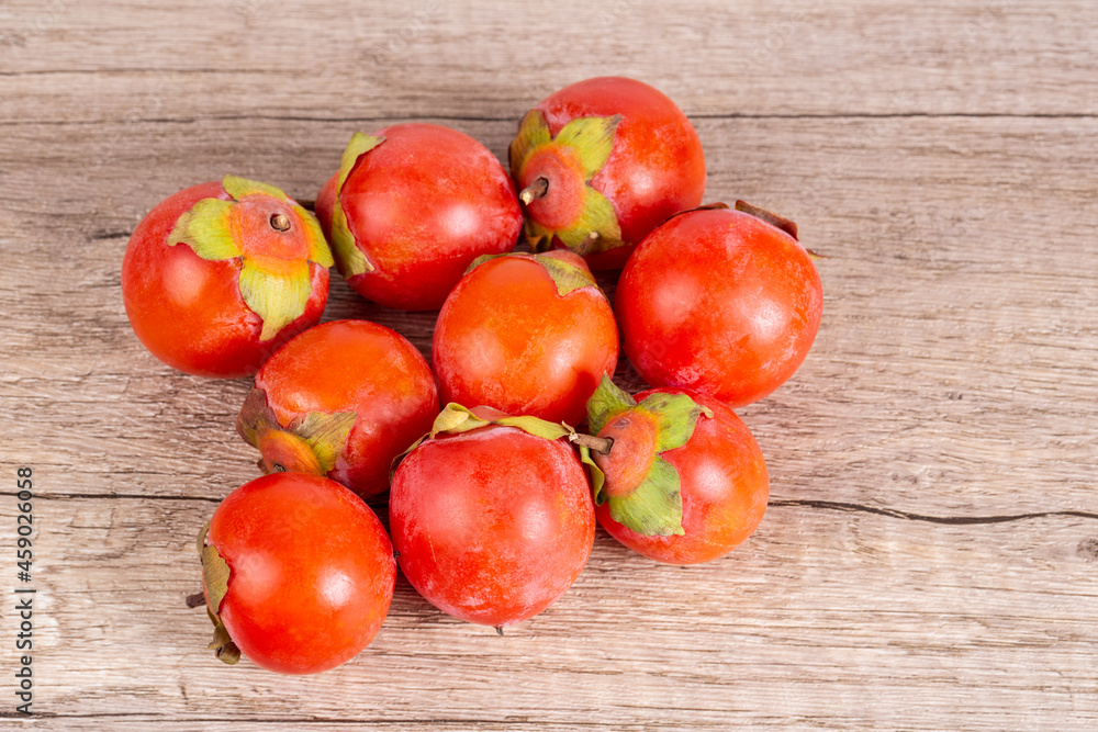 persimmons on wooden table background