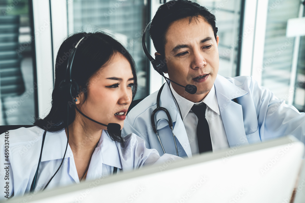 Doctor team wearing headset talking actively on video call in hospital clinic . Concept of telehealt