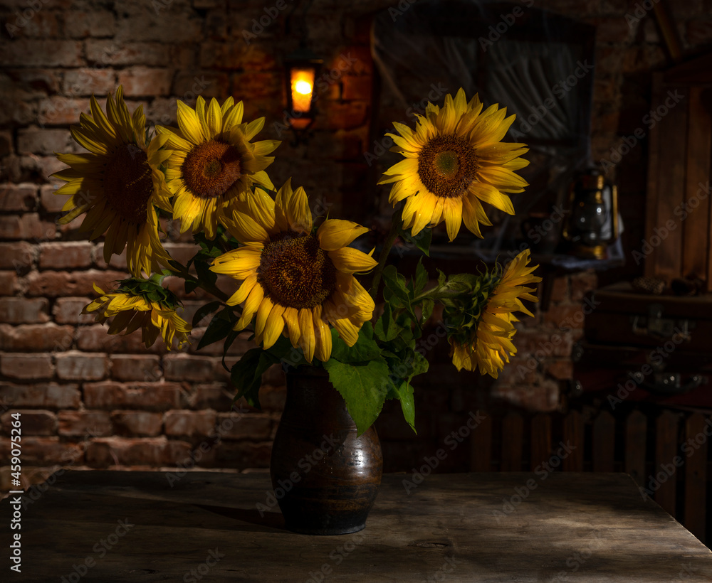 Beautiful bouquet of sunflowers in vase on a wooden table