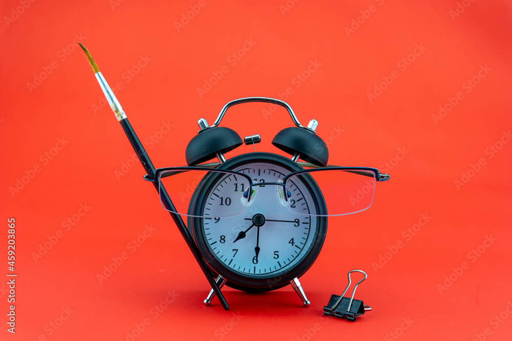 Concept Education or business Alarm clock and teacher glasses Business objects isolated on colorful 