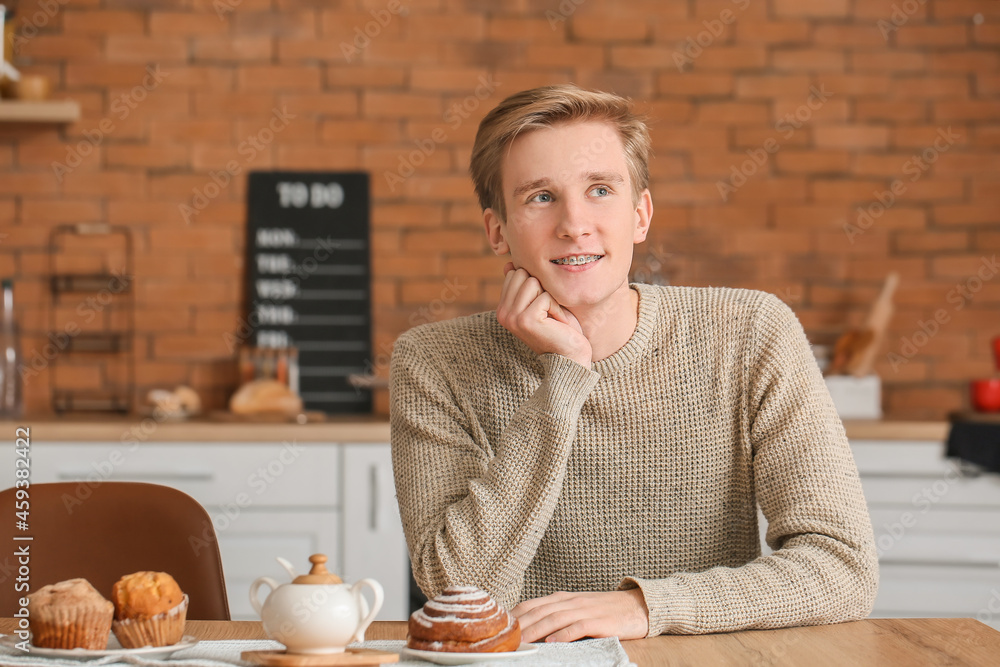 Handsome man with dental braces in kitchen