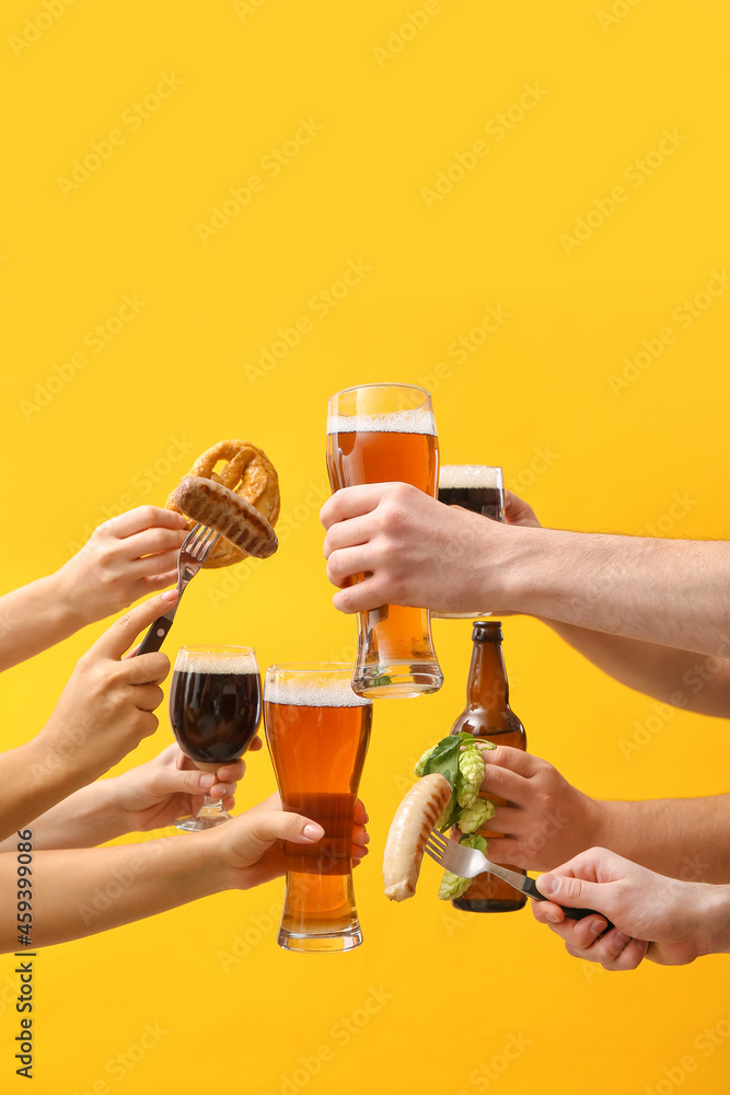 Hands with beer and snacks on color background