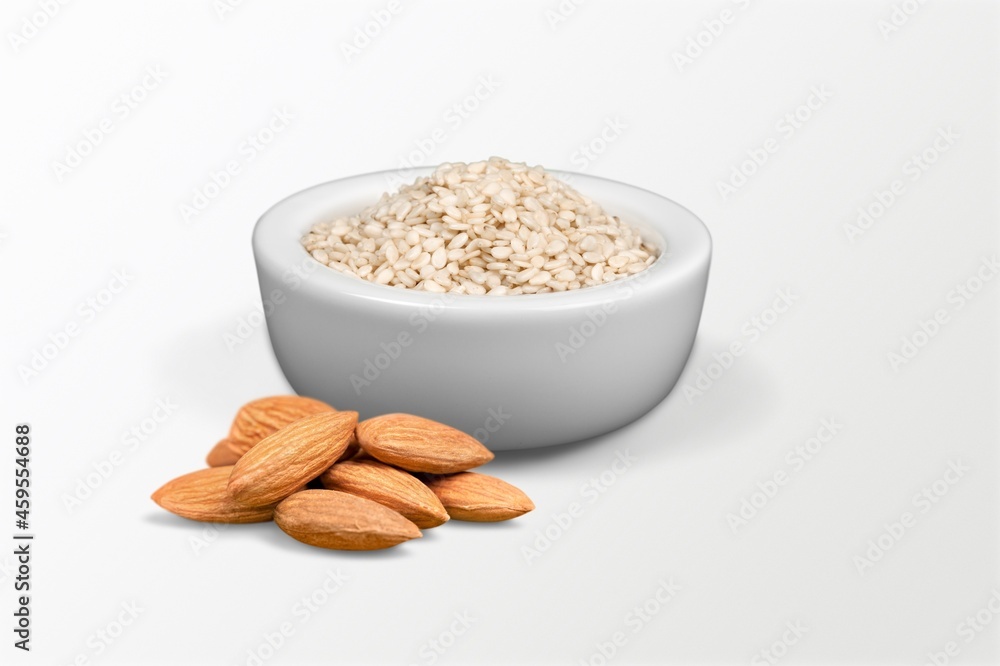 Almond flour in the bowl and almonds nut on the desk