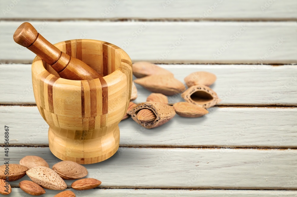 Almond flour in the bowl and almonds nut on the desk