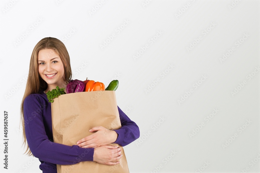 Online home delivery, internet orders and grocery shopping concept. Excited woman with a bag