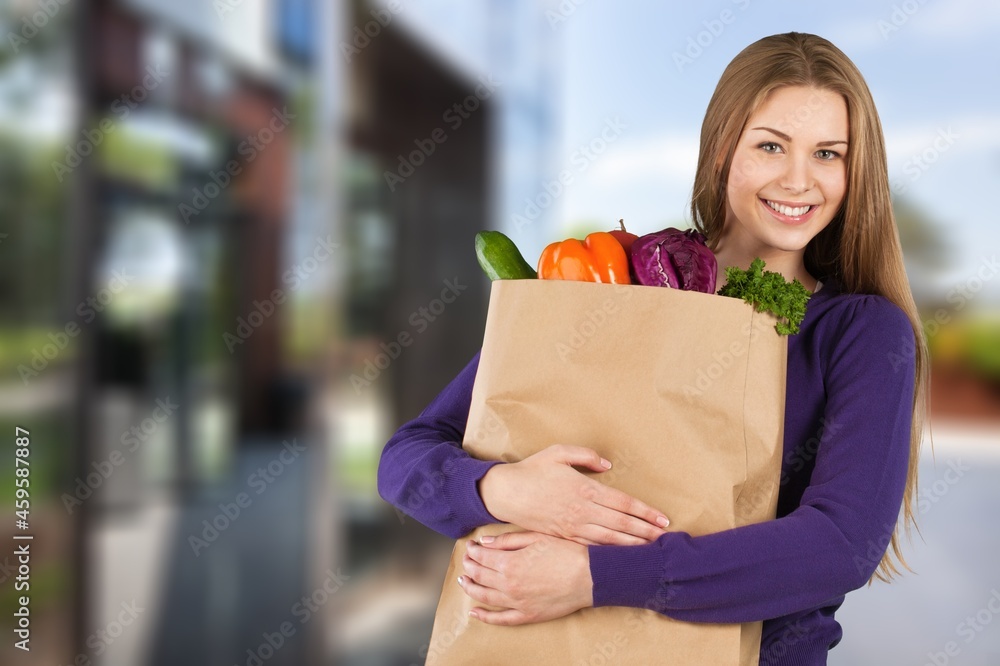 Online home delivery, internet orders and grocery shopping concept. Excited woman with a bag