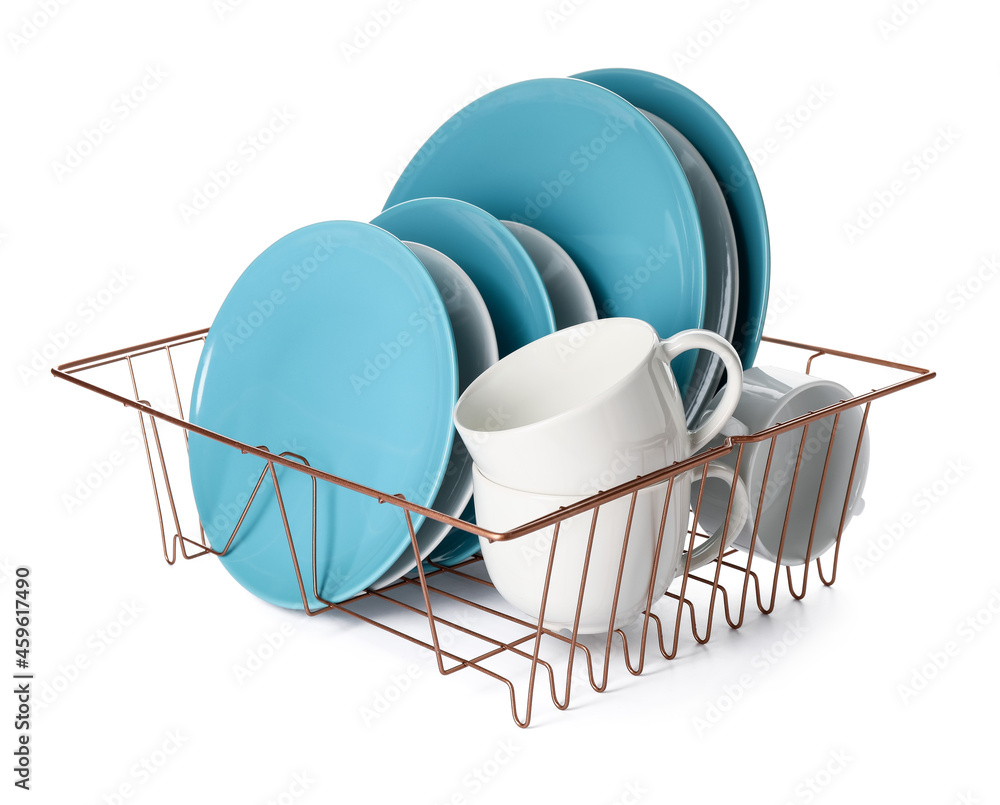 Set of clean dishes in drainer on white background