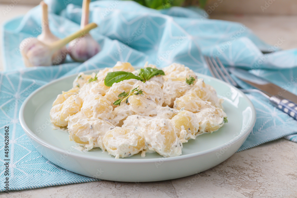 Plate of delicious gnocchi with creamy sauce on table