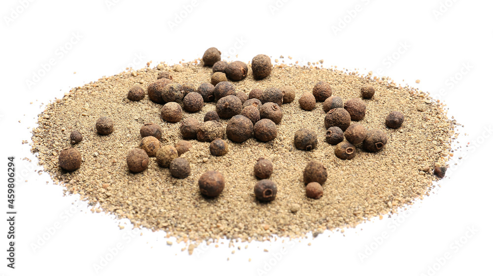 Heap of allspice powder and peppercorns on white background