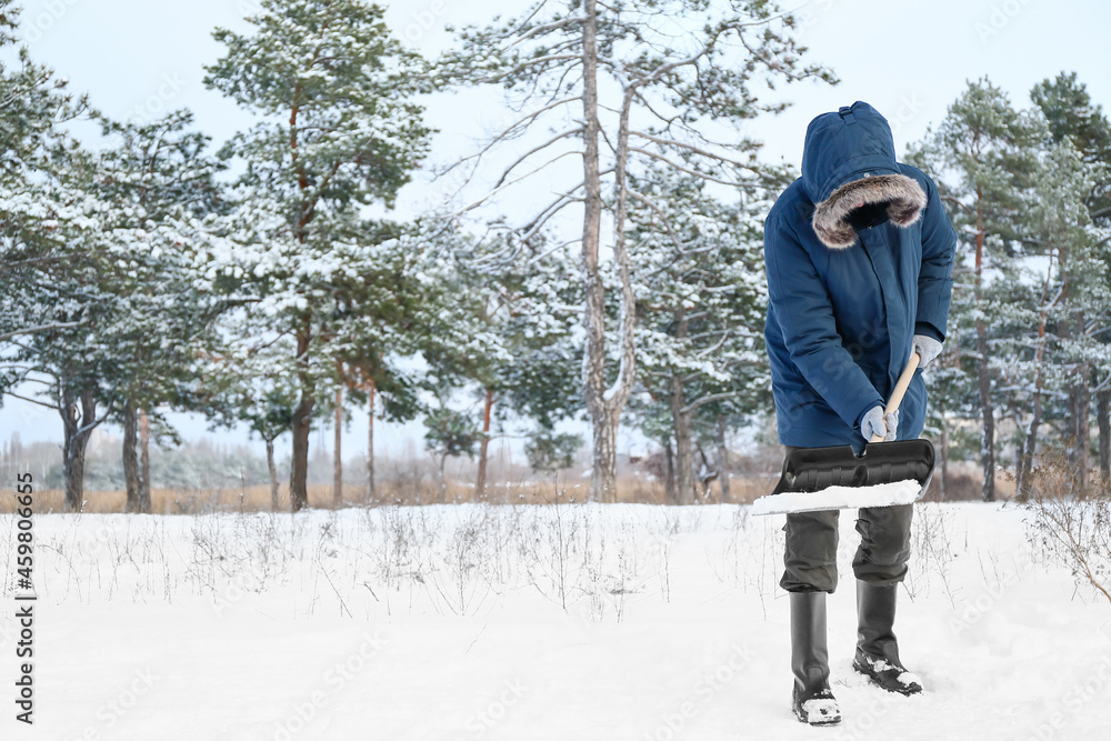 Man removing snow with shovel on winter day