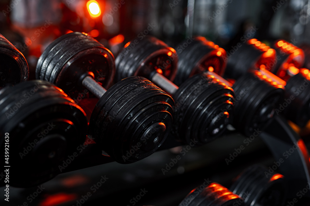 Gym training heavy weights on stacks. Fitness workout row of weights lined up in a gym.