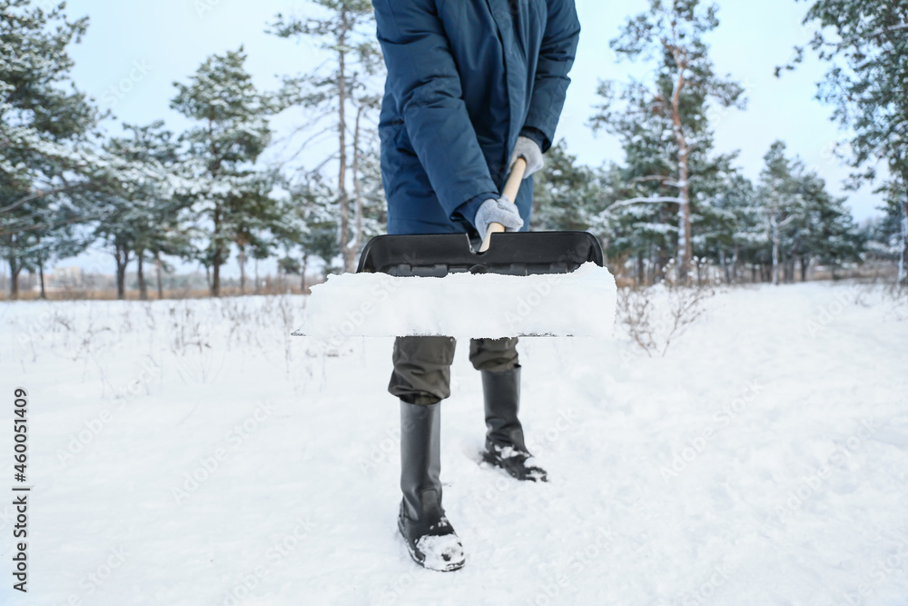 Man removing snow with shovel on winter day