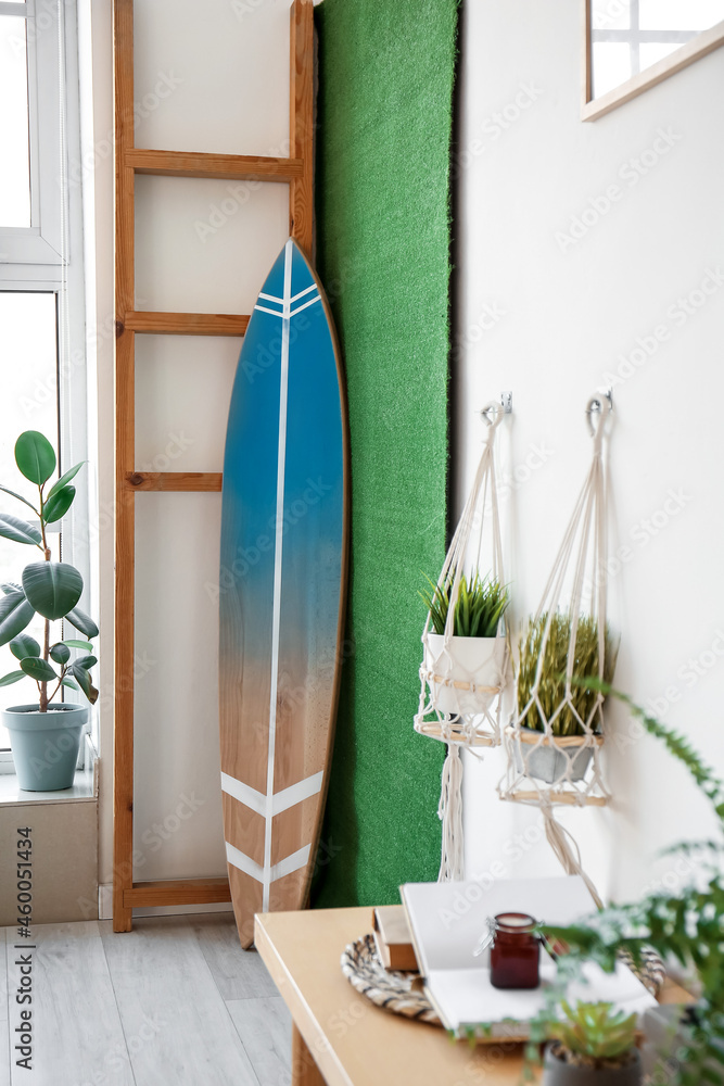 Interior of stylish room with surfboard