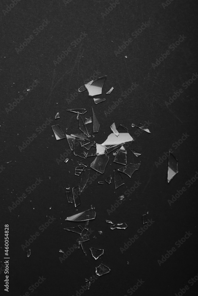 Pieces of broken glass on black background