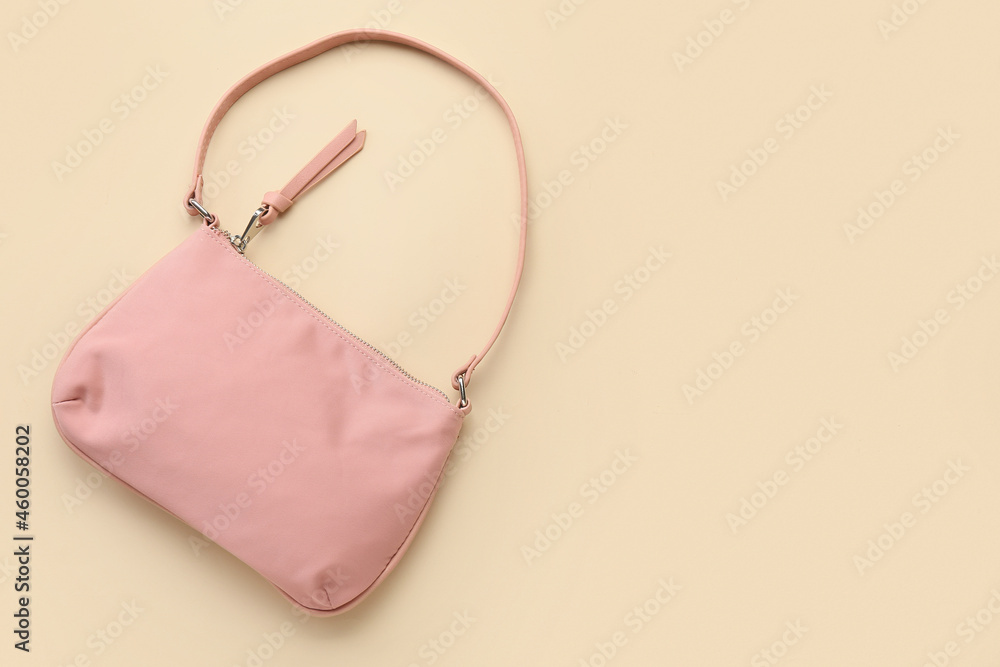 Stylish handbag on color background