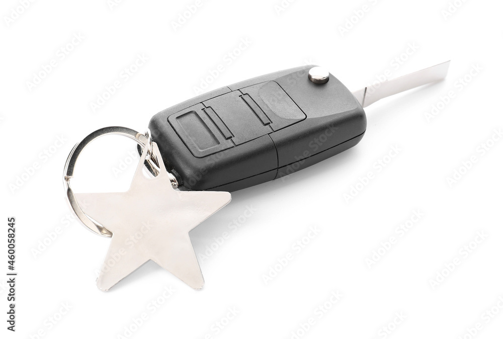 Car key with star shape keychain on white background