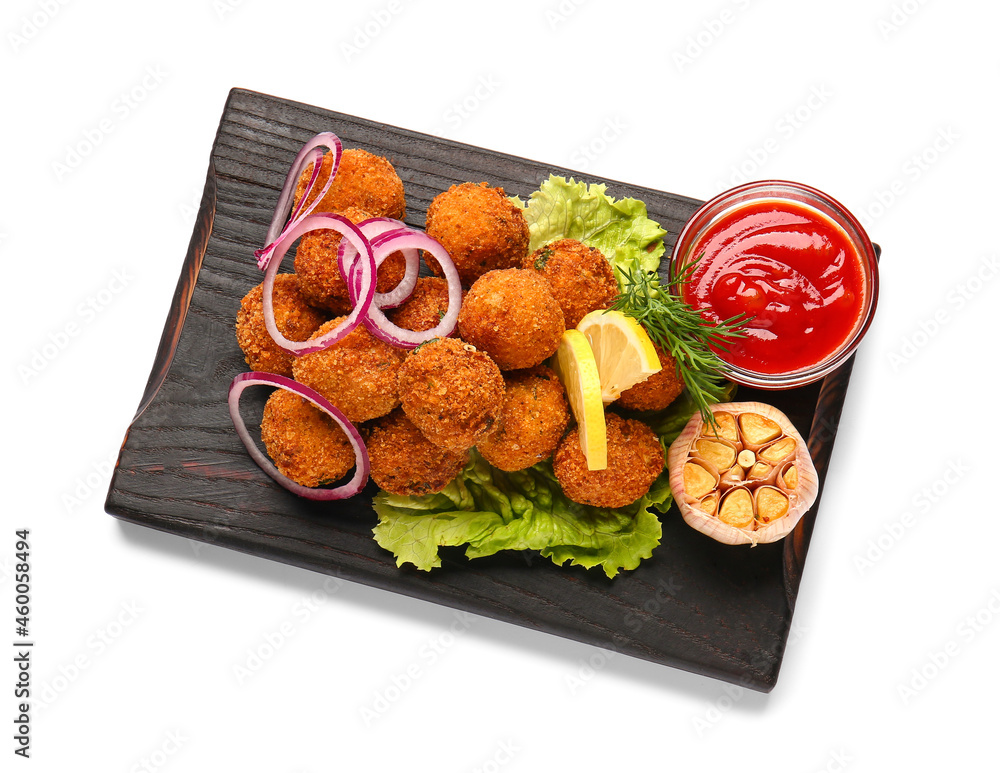 Board with tasty cod cutlets and sauce on white background