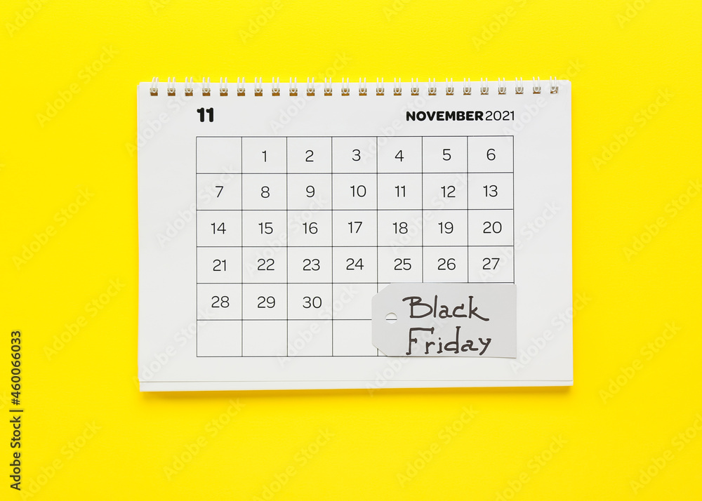 Calendar page of November 2022 on color background. Black Friday